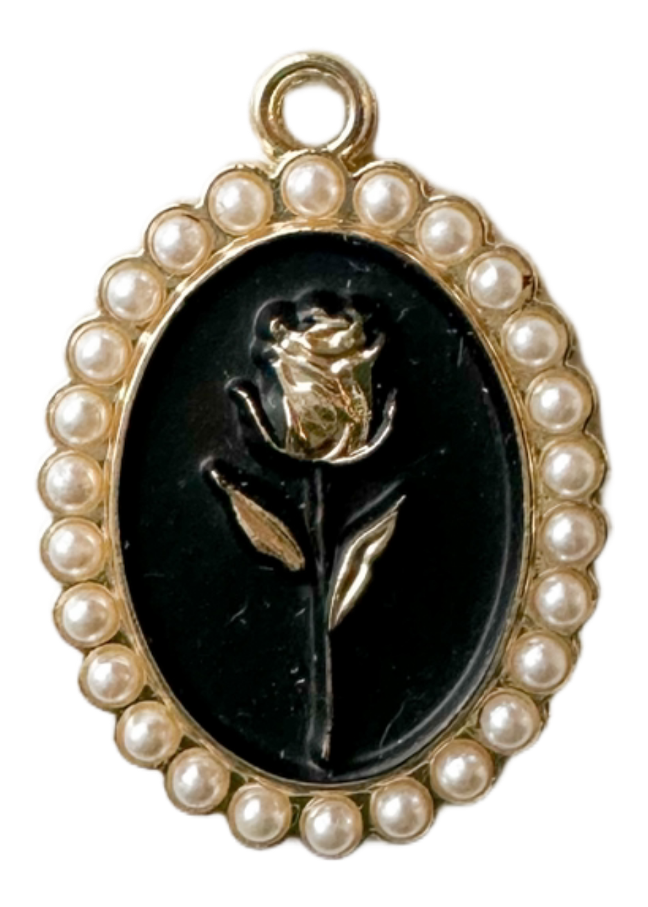 Black oval charm with gold rose and pearl outline