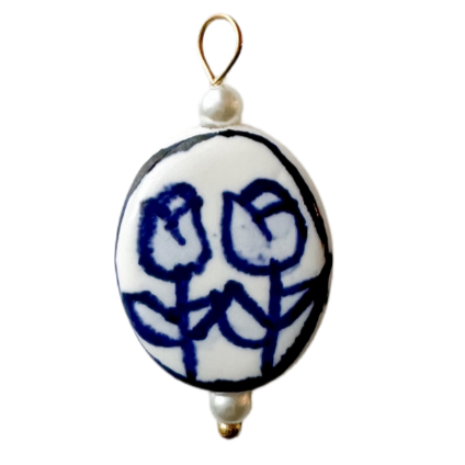 white porcelain charm with blue dutch style tulips and pearl accents