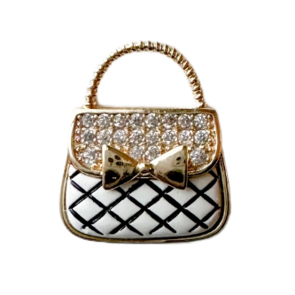 gold and white purse charm with pave crystal and bow accent